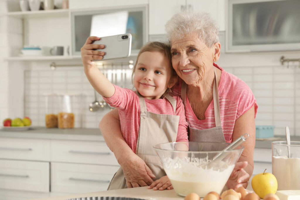 Proveer at Northgate | Seniorand granddaughter baking and taking a selfie together