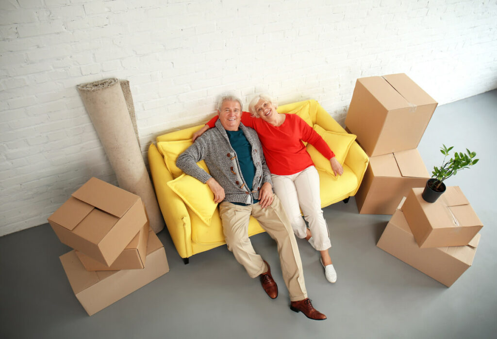 Proveer at Northgate | Senior couple on couch surrounded by boxes
